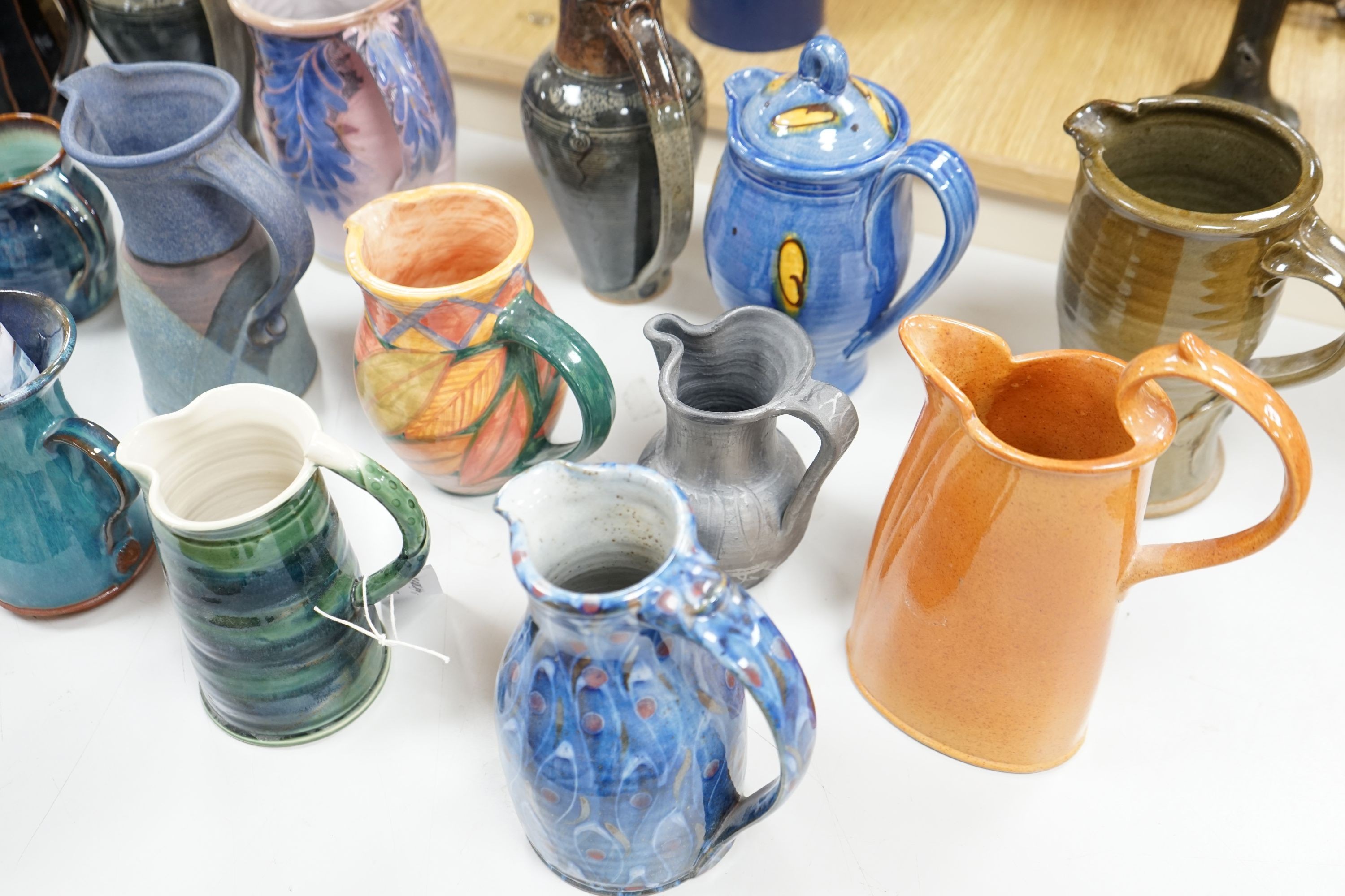 A group of studio pottery jugs to include - 27cm